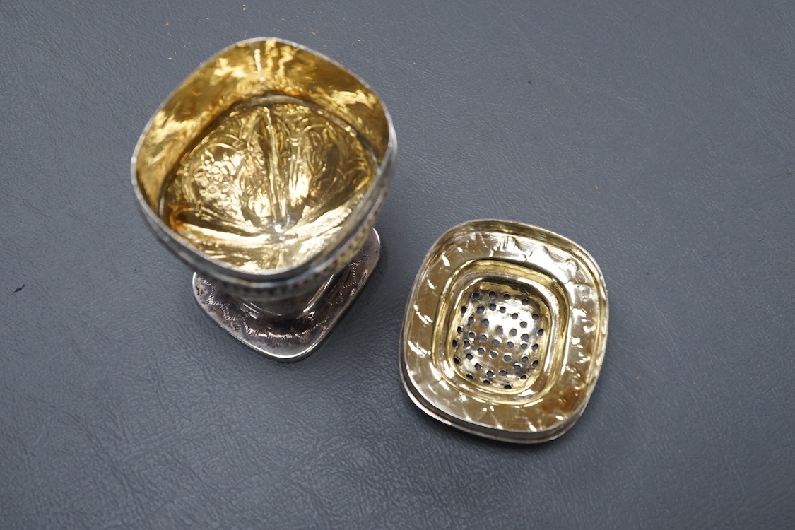 A George III silver octagonal nutmeg grater by Phipps & Robinson, London, 1810, 46mm(a.f.), together with a George III silver pedestal pepperette, by Alice & George Burroughs, London, 1808, 70mm.